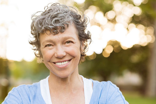 Woman smiling after receiving dental bridge at Nancy Shiba, DDS.