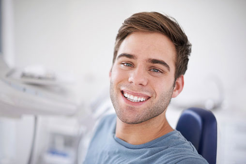 Young man smiling after composite filling at Nancy Shiba, DDS.