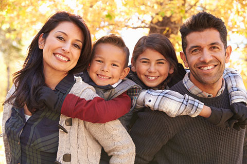 Image of a young family smiling after their dental visits at Nancy Shiba, DDS.