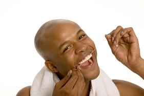 A man flossing his teeth.