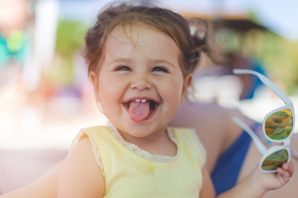 toddler sticking tongue out and smiling